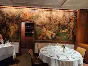 Dining area and decorative mural at The Leopard at Des Artistes. Photo by Sora Vernikoff