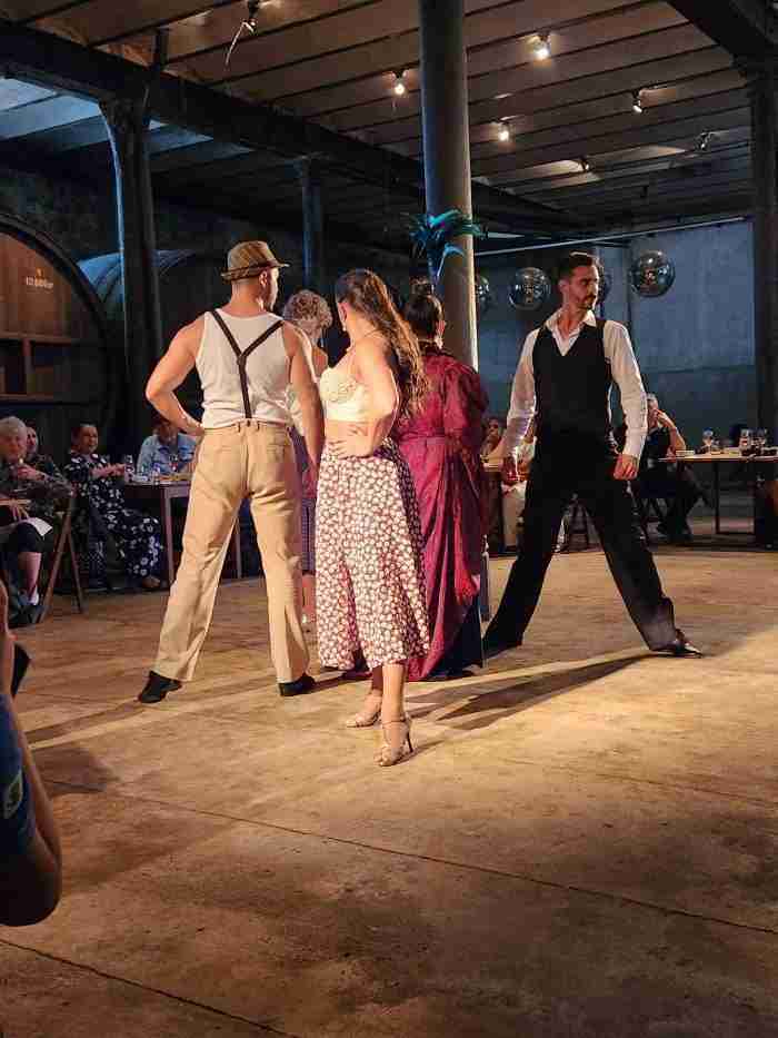 A group of people dancing in a room Description automatically generated with medium confidence