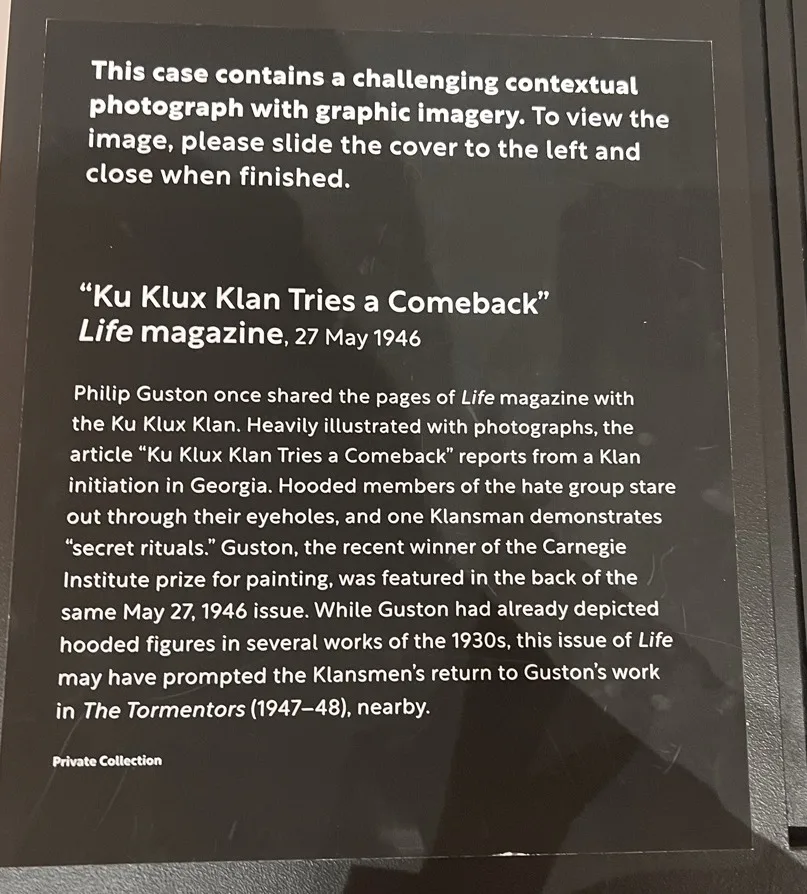 Warning about a display case showing magazine articles with photos of the KKK. Photo credit: Elizabeth Ann Foster