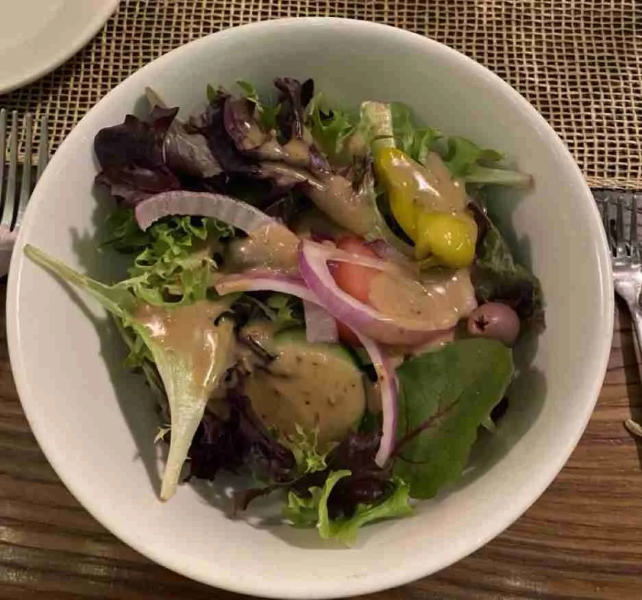 House salad beautifully fresh mixed greens, cucumbers, tomatoes, pepperoncini, olives, red onion, light balsamic dressing at Spano's. Photo by Valérie Blanchard