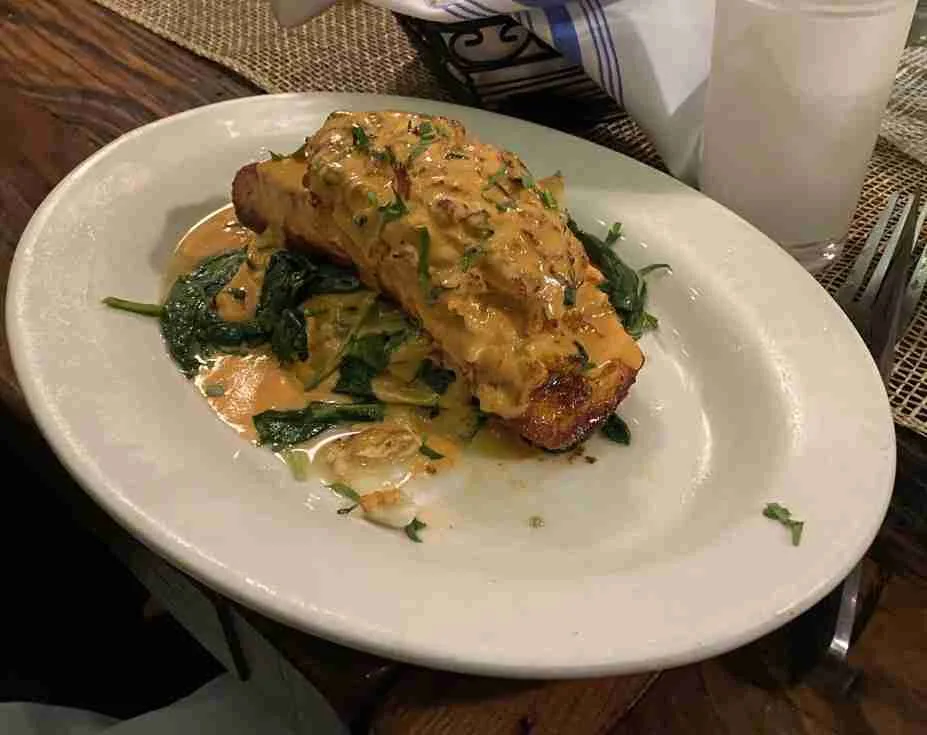 Salmon Paesano, salmon fillet stuffed with lump crab meat topped with a light creamy seafood sauce served with sauteed spinach at Spano's. Photo by Valérie Blanchard