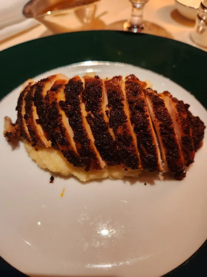 A close up of blackened chicken with polenta at Casa Cruz New York. Photo by Sora Vernikoff