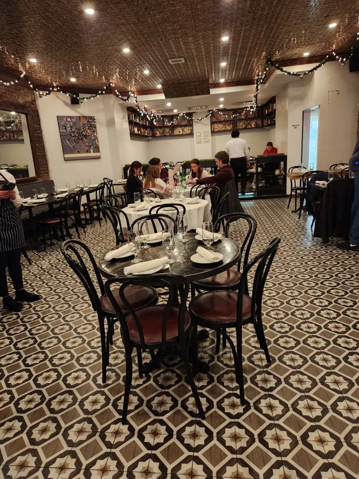 Dining scene with atmospheric lighting and mosaics at Bocca di Bacco Italian Restaurant in Manhattan's Hell's Kitchen. Photo by Sora Vernikoff