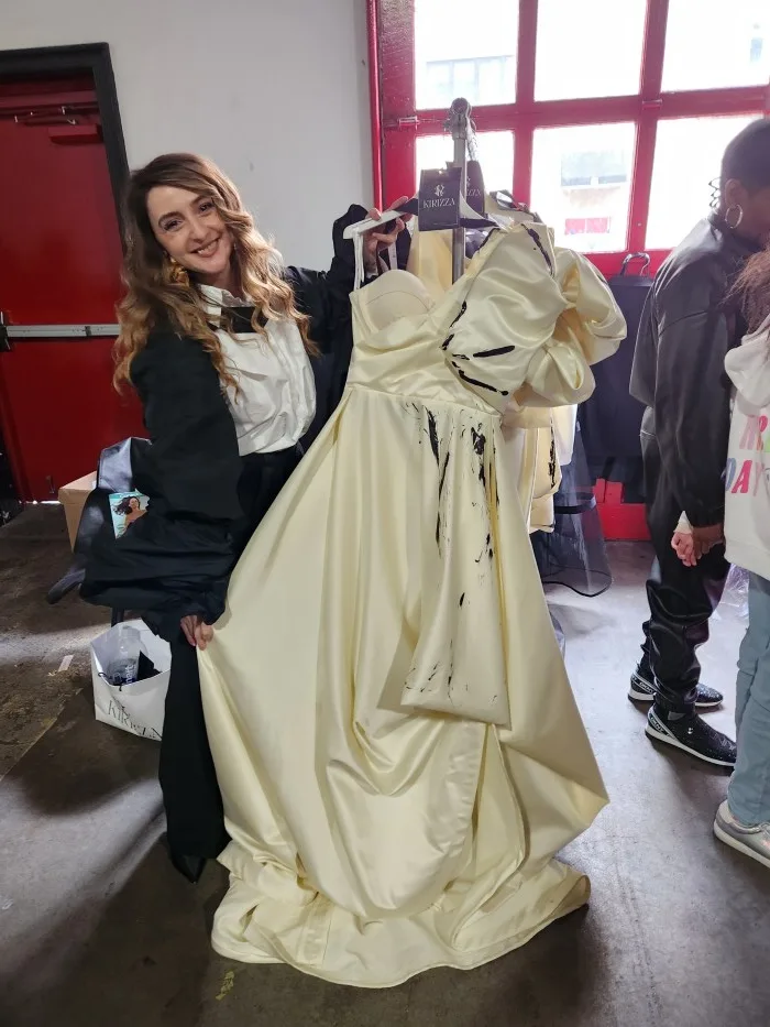 A person in a white dress Description automatically generated