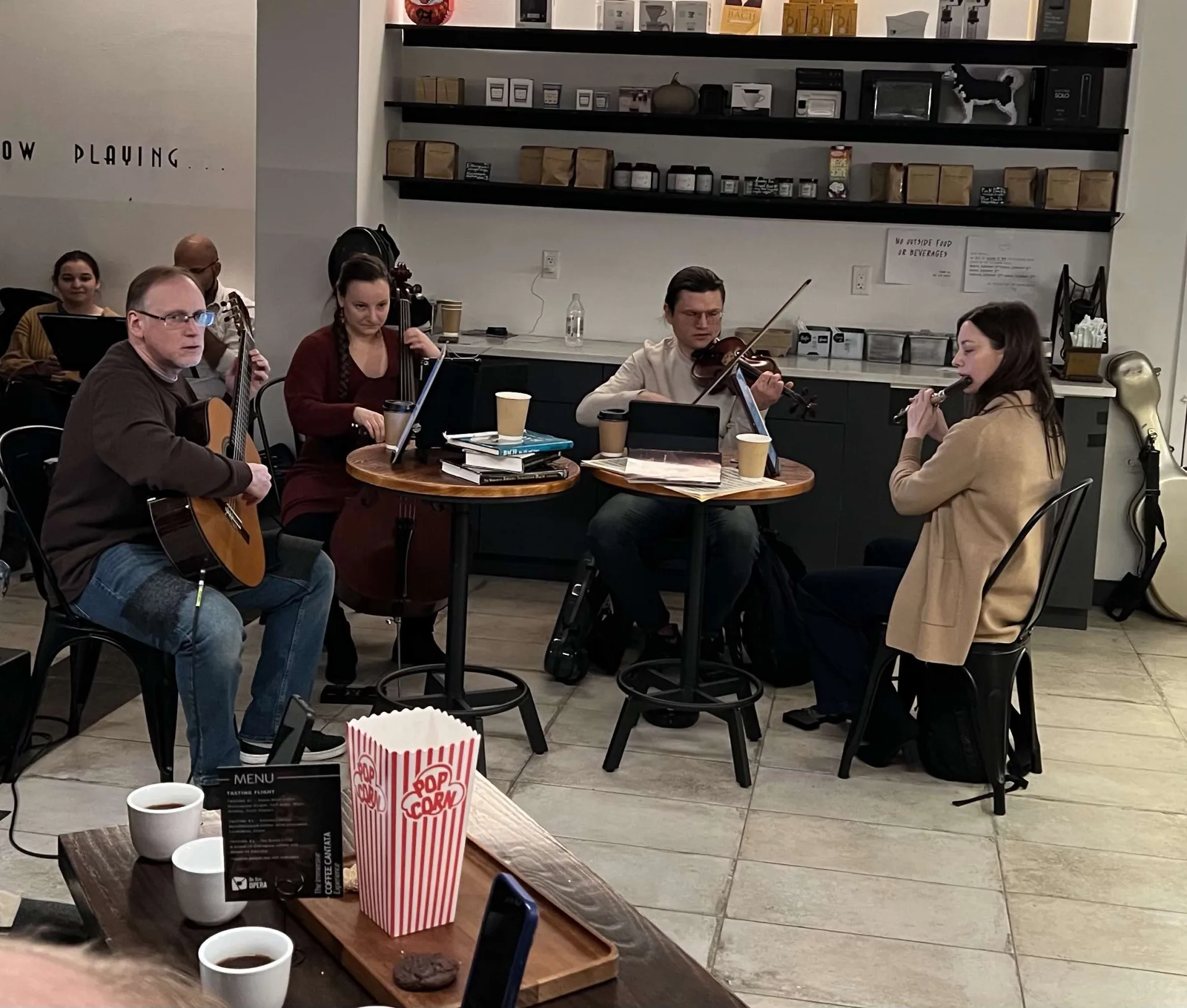 L-R: Guitar Dan Lippel, Cello Valeriya Sholokova, Violin Nikita Yermack, and on Flute/recorder Anna Urrey for the On Site Opera presents The Immersive Coffee Cantata Experience at The First Draft in New York City's East Village. Photo by Edward Kliszus