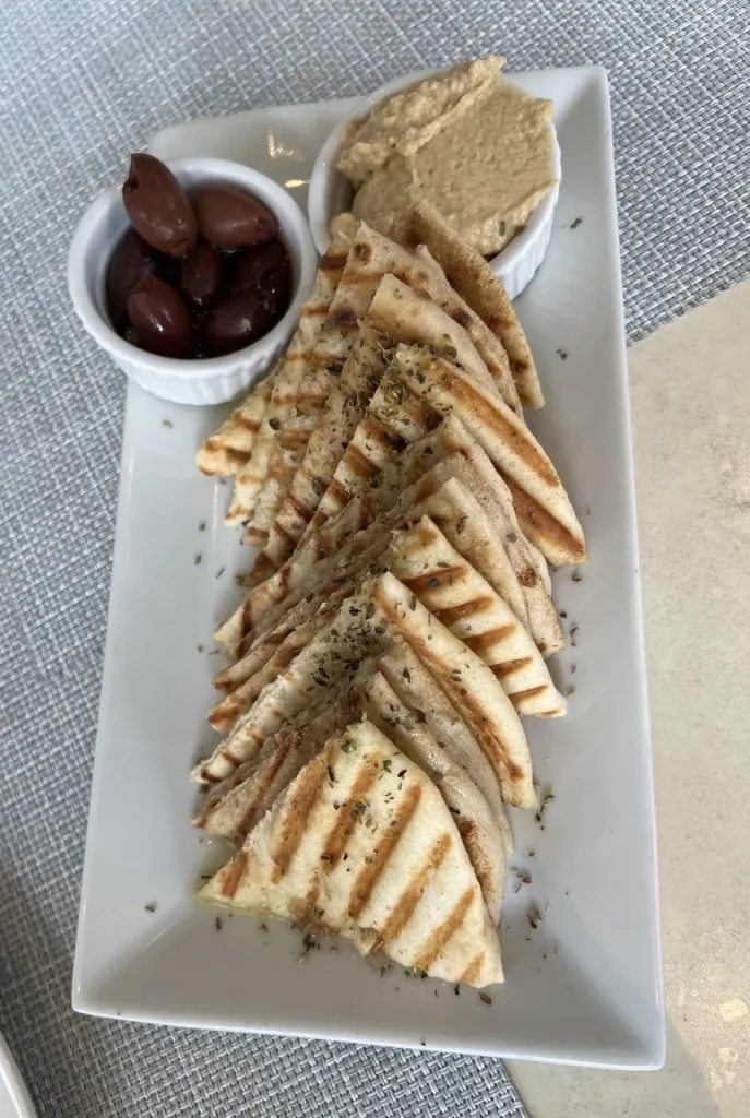 Delicious, hot, Pita Bread with hummus and olives at Ethos. Photo by Valérie Blanchard