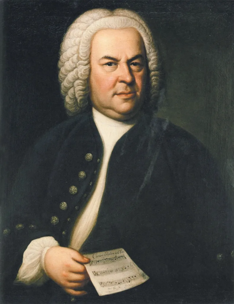 Johann Sebastian Bach (aged 61) in a portrait by Elias Gottlob Haussmann, second version of his 1746 canvas. Public Domain