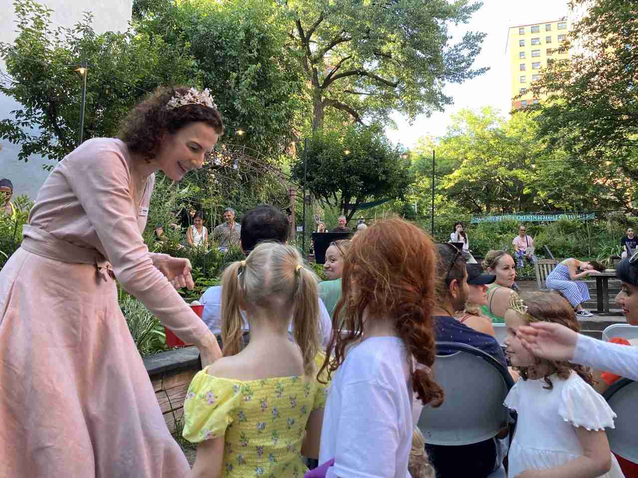 Sarah Ina Meyers, Narrator, distributing rocks to children to help Hansel and Gretel in Opera in the Garden by the ON SITE OPERA. Photo by Edward Kliszus