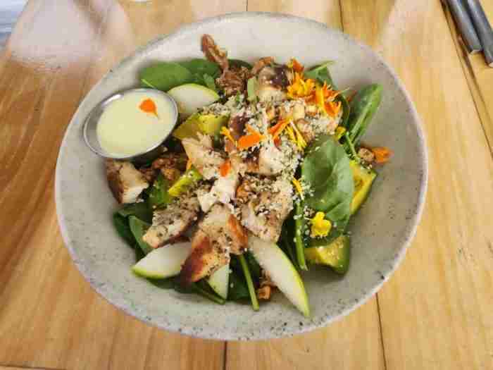 Chicken Avocado Salad with Baby Kale, Spinach, Green Apple, Candied Walnuts, Grilled Chicken, and Creamy Lemon Pepper Dressing at Ruby's Cafe in New York's East Village. Photo by Sora Vernikoff