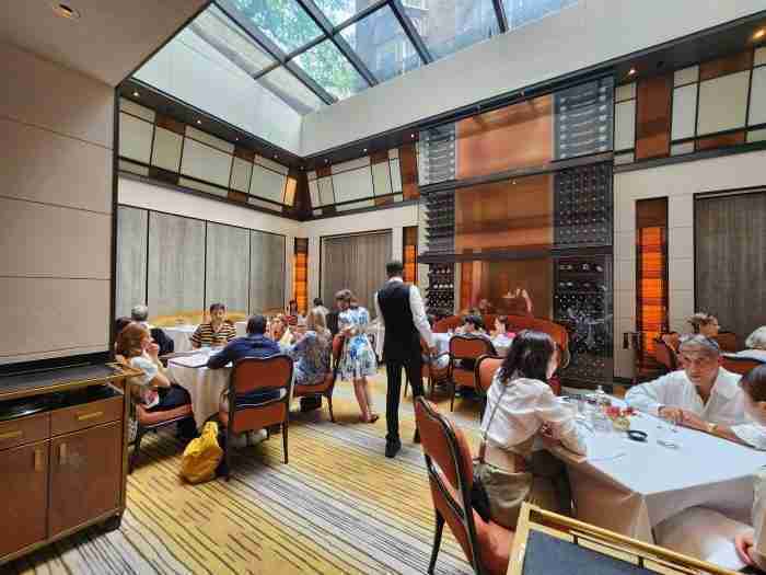 A beautiful, sky-lit dining area at The Mark Restaurant by Jean Georges & The Mark Bar. Photo by Sora Vernikoff