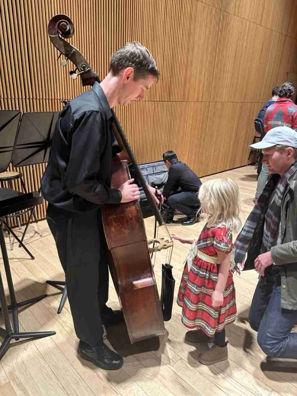 A child plucking a string bass string. Courtesy PACS