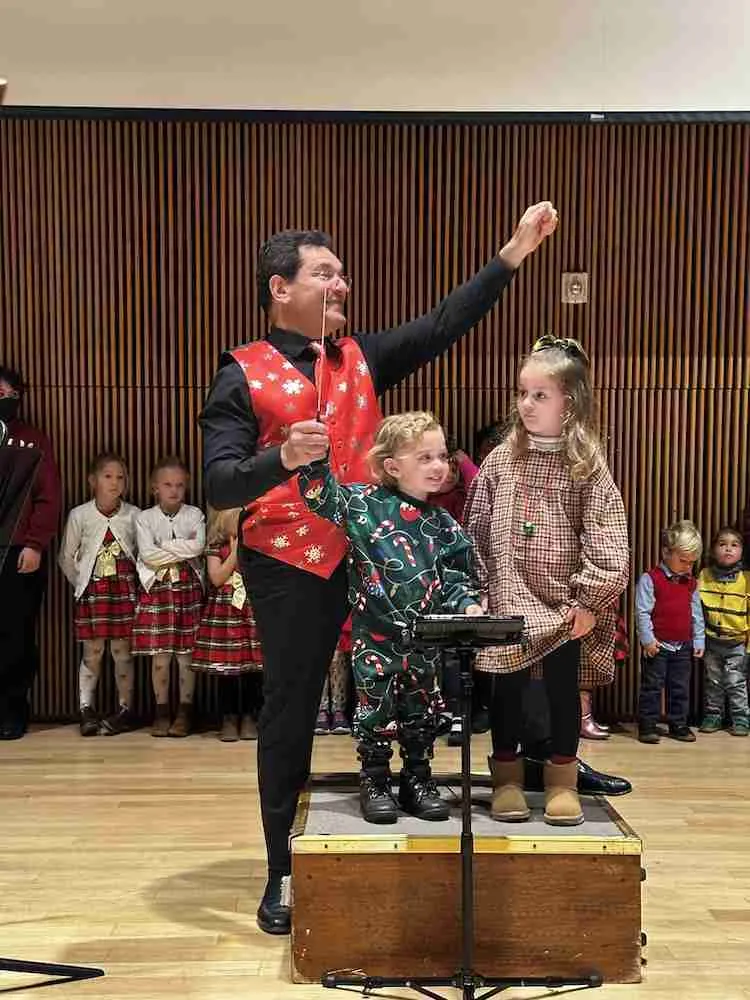 Children invited to help Maestro Bernard conduct the Waltz of the Flowers. Photo by Edward Kliszus