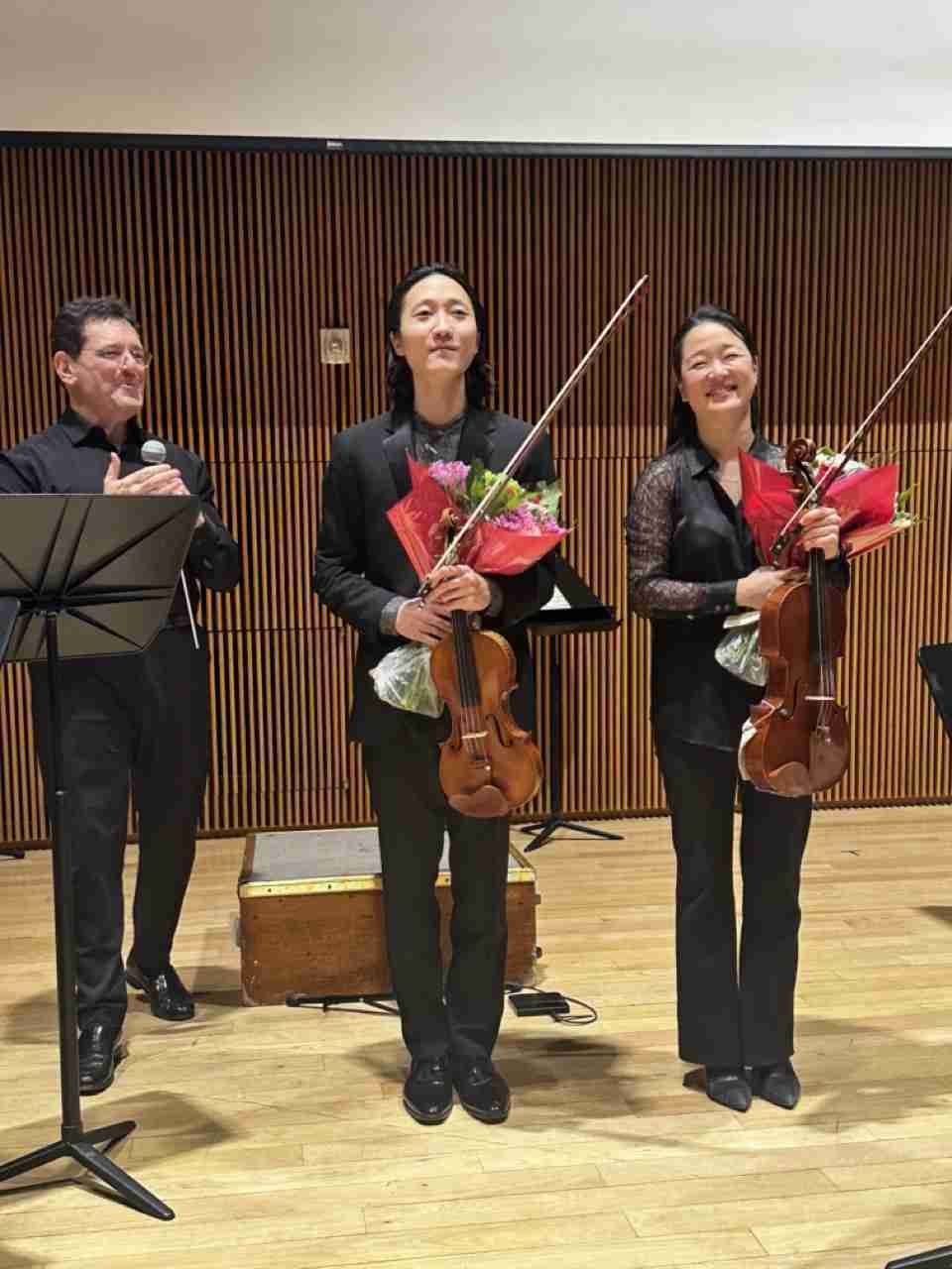 Conductor David Barnard and soloists Sean Lee, Violin, and Katharina Kang Litton taking bows after performing Mozart's Sinfonia Concertante in E-flat major, K. 364 in the Park Avenue Chamber Symphony's "Immersive Mozart" concert experience at the DiMenna Center for Classical Music in New York City. Photo by Edward Kliszus