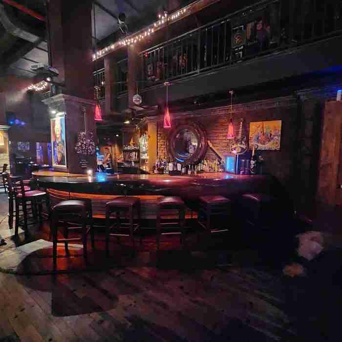 A bar with chairs and a mirror AI-generated content may be incorrect.