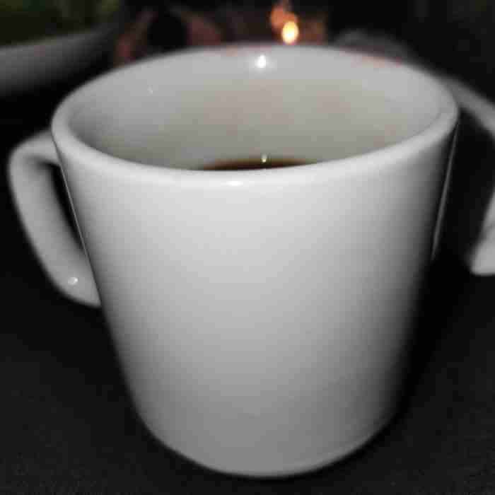 A white cup with a handle AI-generated content may be incorrect.