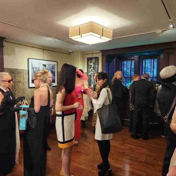 A group of people standing in a room AI-generated content may be incorrect.