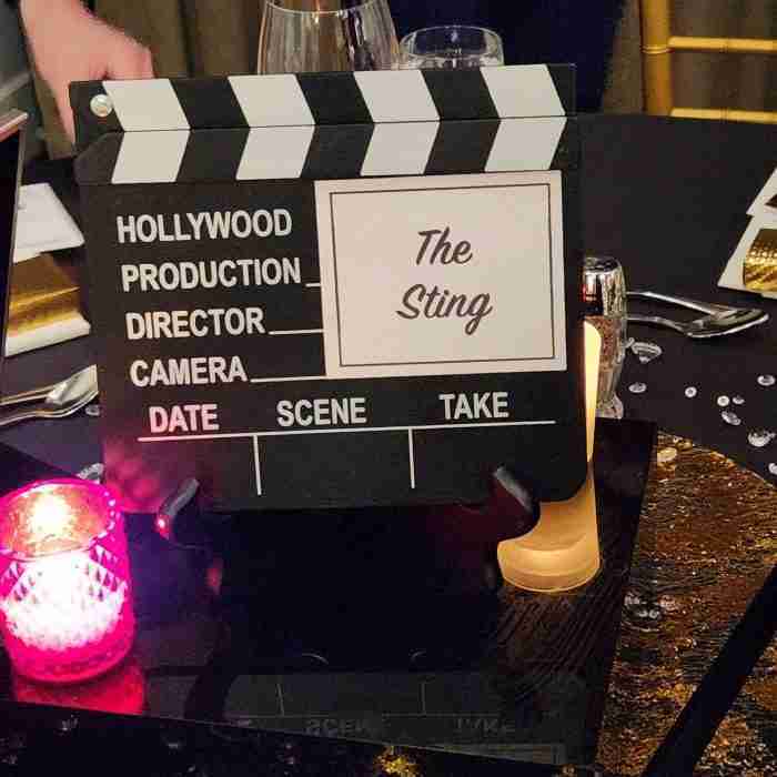 A movie clapper board on a table AI-generated content may be incorrect.
