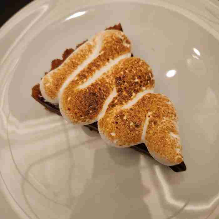 A piece of pie with a smores on top AI-generated content may be incorrect.