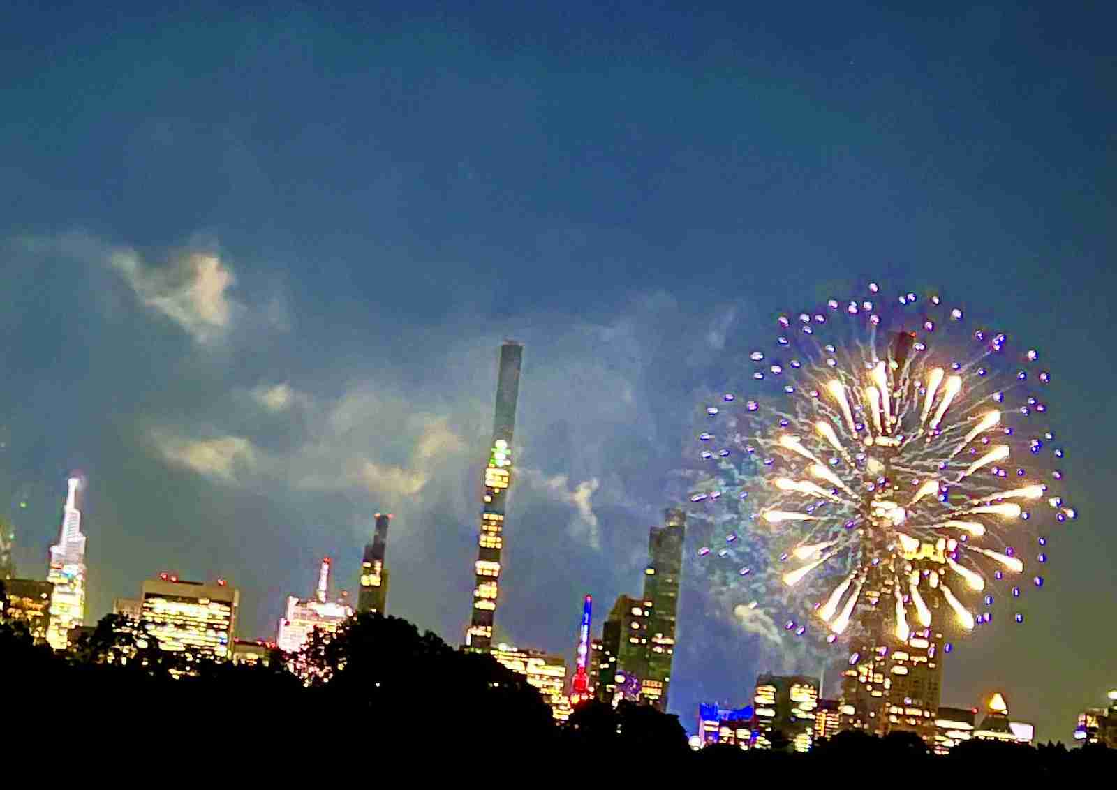 Facing towards the famed neighborhood of Central Park South and fireworks after a concert by the NY Philharmonic in New York City's Central Park. Photo by Edward Kliszus