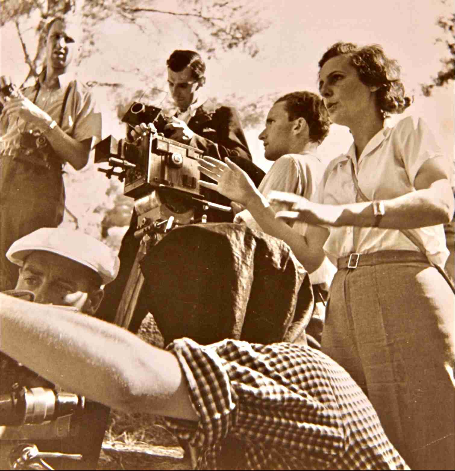 A team of the Berlin-based Olympia-Film G.m.b.H. during a shoot for the Olympia movie picture in summer 1936. On the right director Leni Riefenstahl (1902–2003), left from her cameraman Walter Frentz (1907–2004). Contemporary gelatin silver print, marked on its backside with a stamp of Olympia-Film G.m.b.H., Berlin S.O. 36. Public Domain via Wikipedia Commons