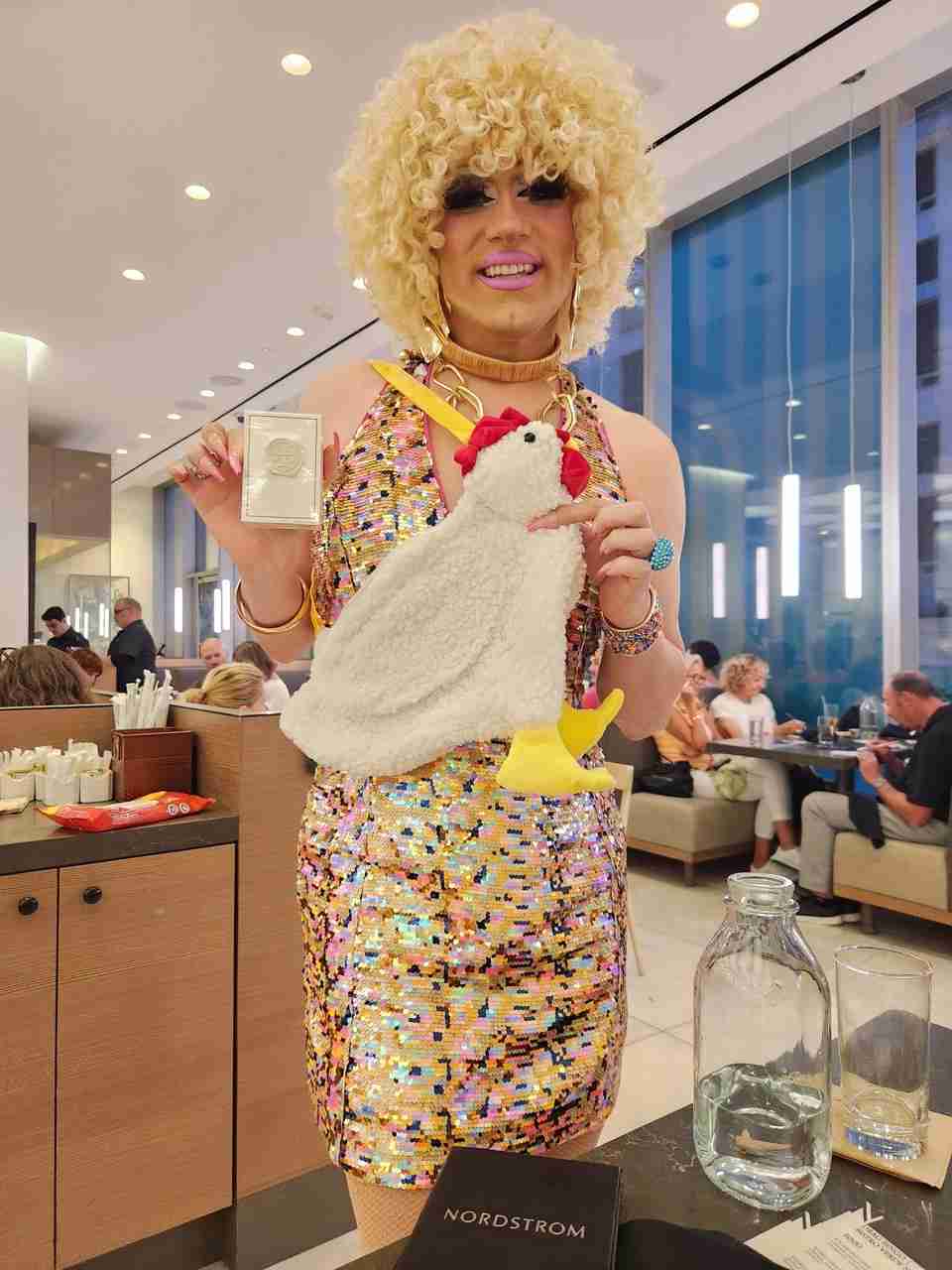Babette showing some of the amazing prizes at Nordstrom NYC Drag Bingo. Photo by Sora Vernikoff