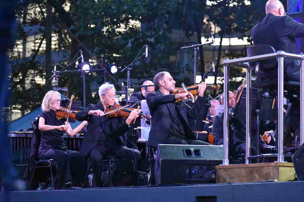 Violins of the American Symphony Orchestra in a concert entitled New York Profiles by the American Symphony Orchestra at Bryant Park. Photo by Edward Kliszus 