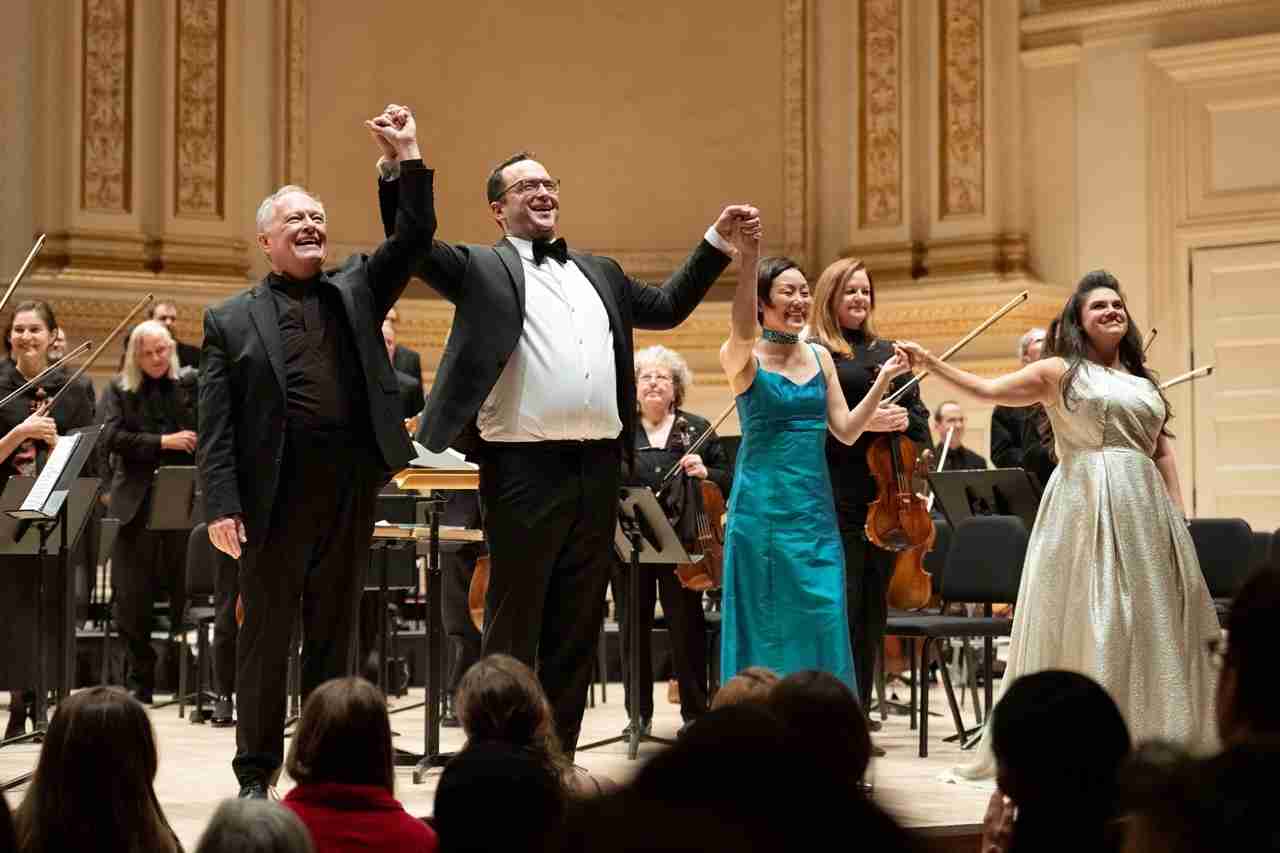 L-R: Maestro Kent Tritle, Guest Conductor Michael Sheetz, Harpist Mariko Anraku, Soprano Kathryn Lewek, and the Chorus and Orchestra of Musica Sacra in Classics for Christmas at Carnegie Hall. Photo by Brian Hatton