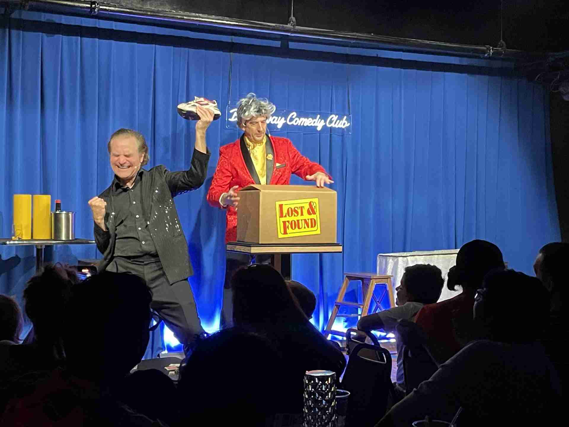 Jim Vines and Carl Mercurio performing in a scene, "Where did the Root Beer Bottle Go?" from The Broadway Magic Hour at the Broadway Comedy Club in New York City. Courtesy Michelle Tabnick PR