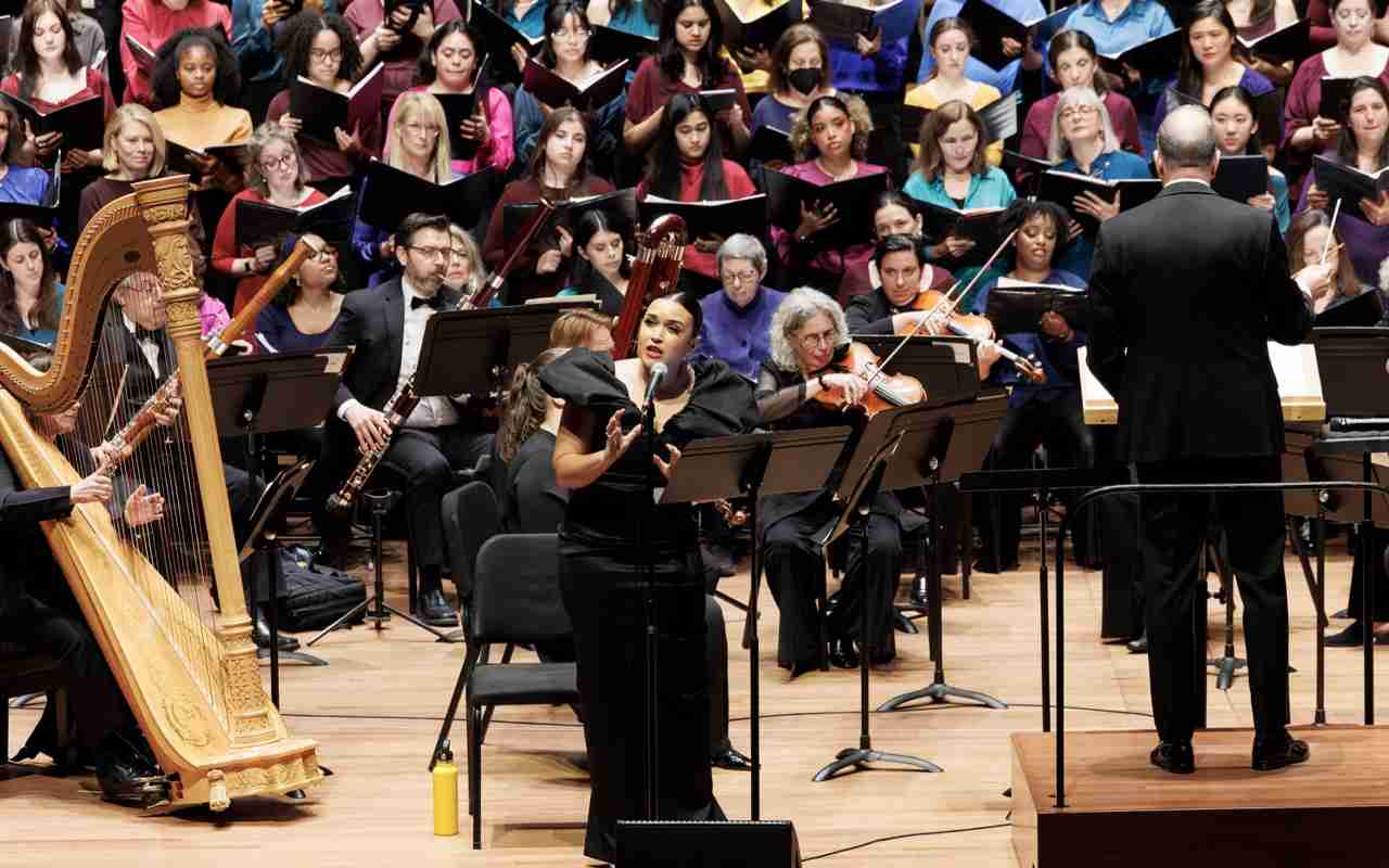 Soloists Mikaela Bennett, soprano, center, with Ted Sperling, conductor, The MasterVoices Chorus and Orchestra of St. Luke's. MasterVoices presents Sins and Grace, conceived and conducted by Ted Sperling, Alice Tully Hall, Lincoln Center, Monday, March 23, 2026. Credit Photo: Erin Baiano