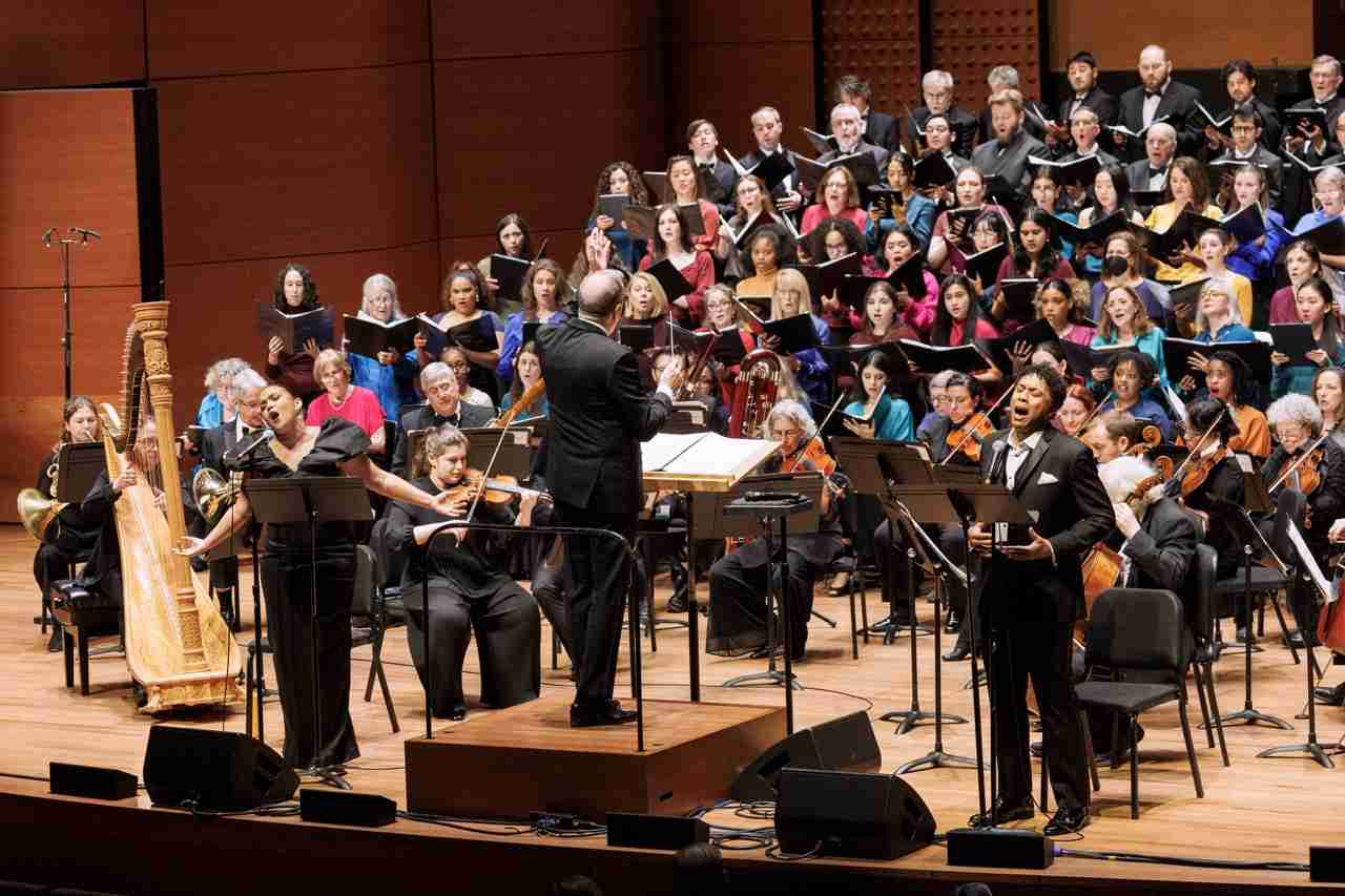 Soloists Mikaela Bennett, soprano, left, and Justin Austin, baritone right, with Ted Sperling, conductor, The MasterVoices Chorus and Orchestra of St. Luke's. MasterVoices presents Sins and Grace, conceived and conducted by Ted Sperling, Alice Tully Hall, Lincoln Center, Monday, March 23, 2026. Credit Photo: Erin Baiano