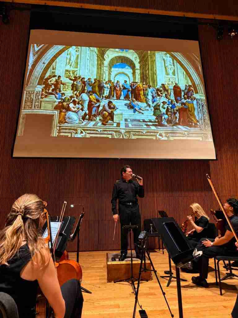 Conductor David Bernard explaining Classical and Romantic music using visual art for comparison with The Park Avenue Chamber Symphony presenting Spellbinding Strauss at the DiMenna Center for Classical Music, NYC. Courtesy chambersympony.com