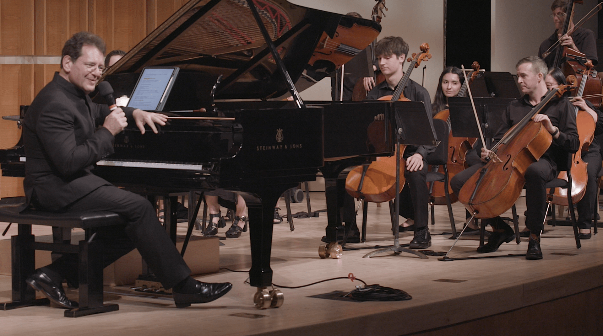 David Bernard introducing the Shostakovich Concerto in C for Piano, Trumpet and String Orchestra, Op. 35, from the piano bench with the Park Avenue Chamber Symphony in the Barbara Brandt Winners' Concert at Merkin Hall. Courtesy The Kaufman Center